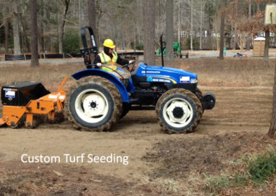 Browder-Hite worker riding a tractor for custom turf seeding services